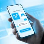 Hand holding smartphone with a blue/white e-commerce chatbot showing product selection and "Confirm Payment" on a futuristic blue background.